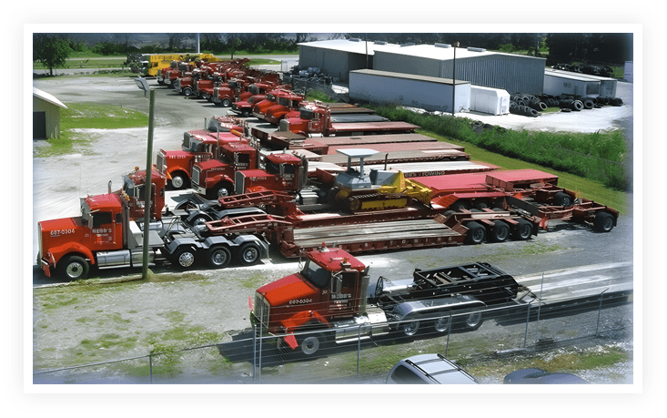 A group of large trucks parked in a lot.