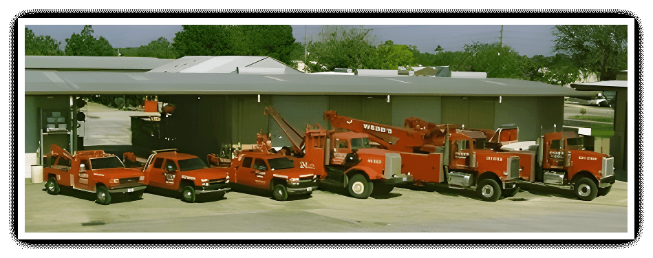 A group of red trucks parked in front of a building.